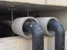 Plastic-jacketed, building-supply pipe under construction
